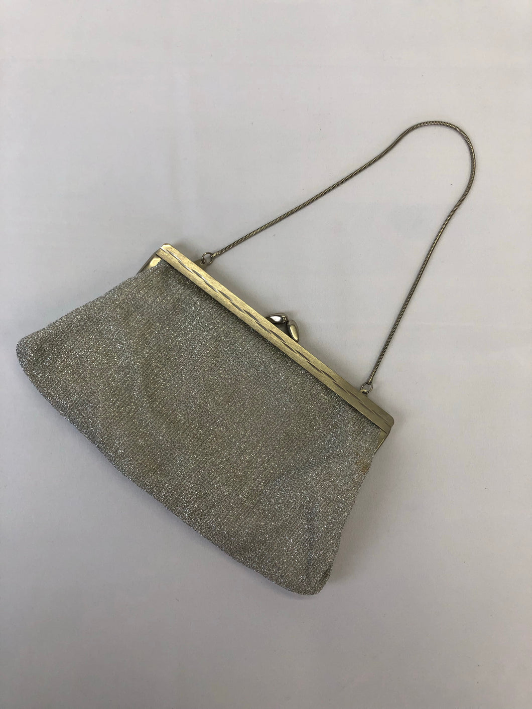 The small vintage silver glitter purse